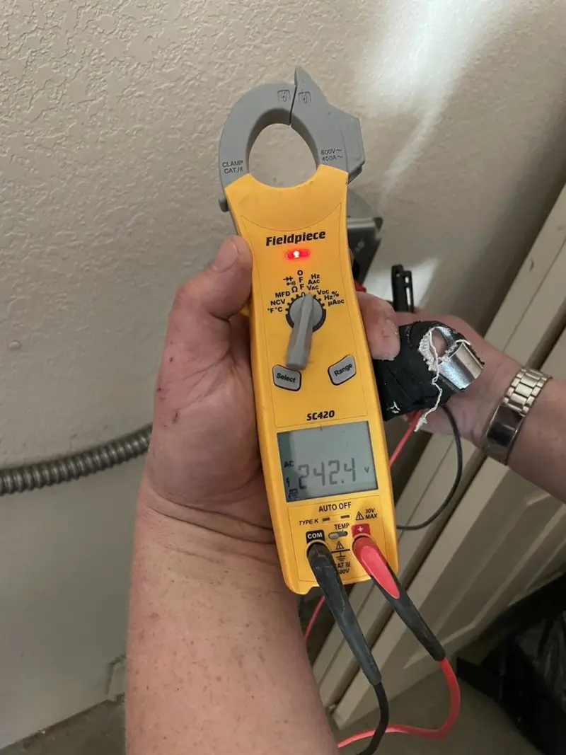 Voltage testing with clamp meter during Whole House Surge Protector in Belpre